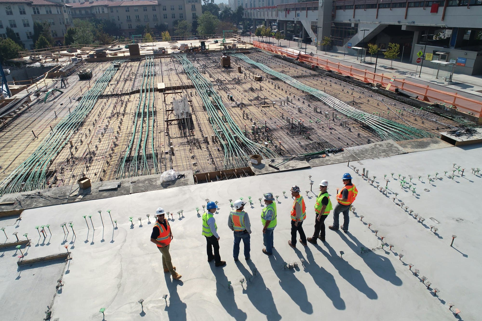 Construction workers in hard hats on a building site — licensed professionals, not DIY